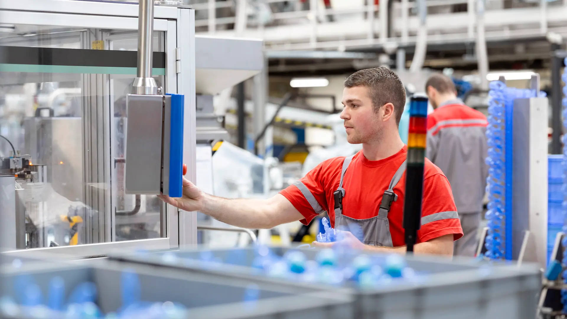 An employee operating a production machine in the Henkel plant in Kruševac, Serbia