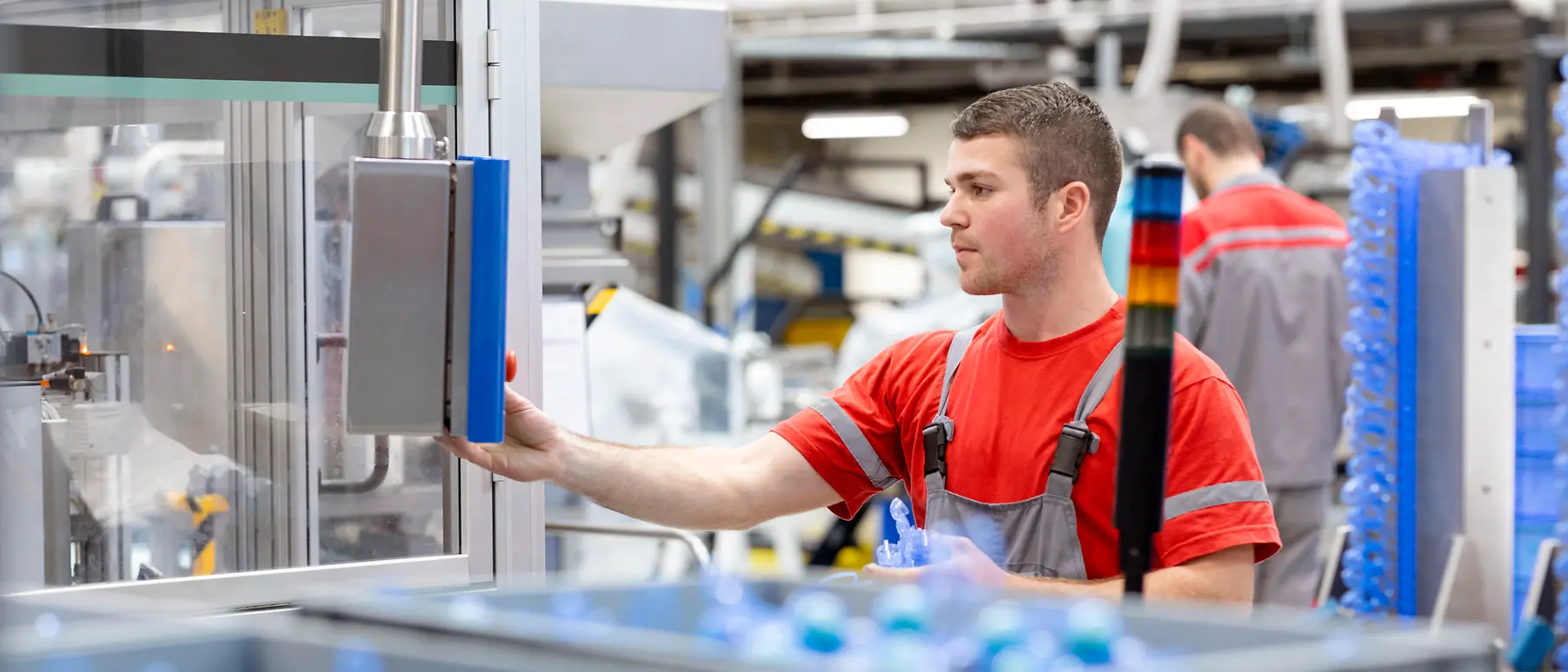 An employee operating a production machine in the Henkel plant in Kruševac, Serbia