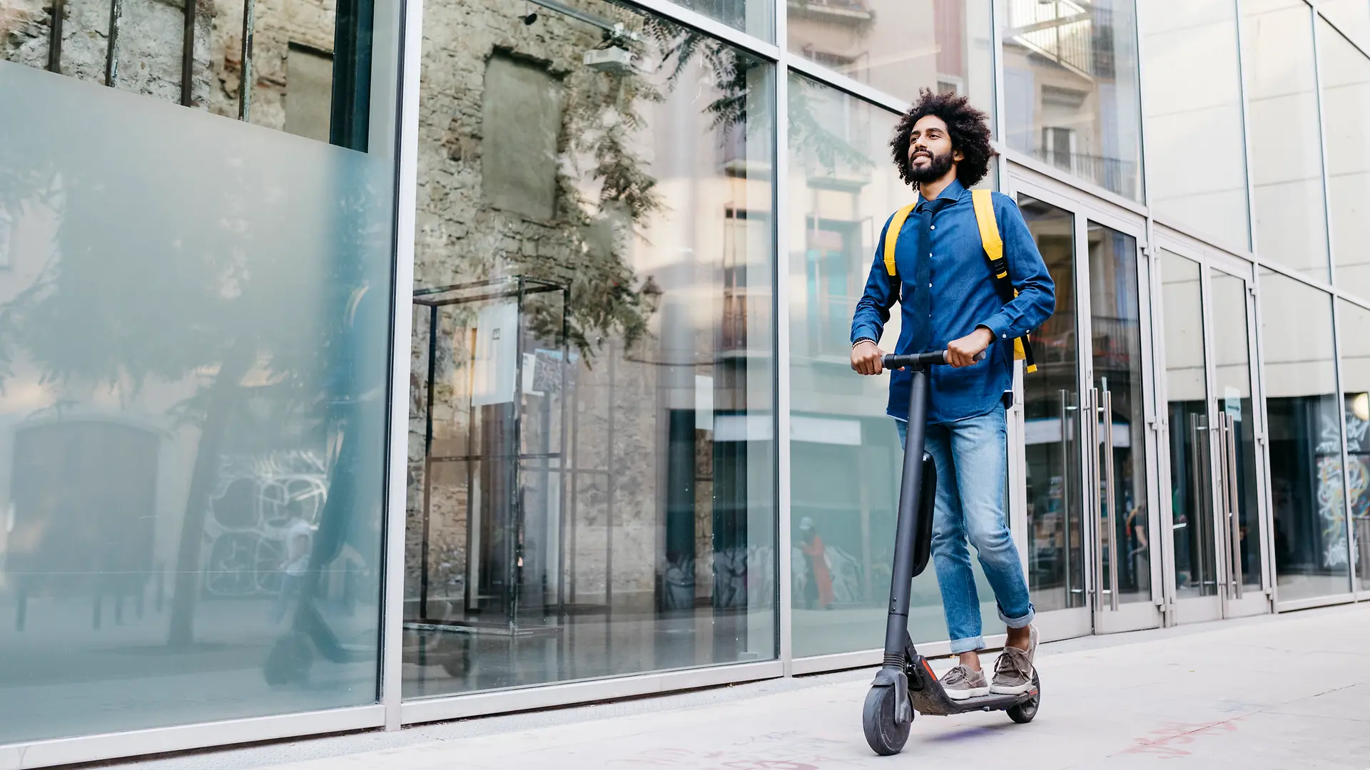 A man rides an e-scooter.