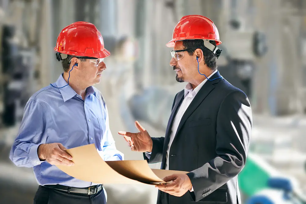 Two factory workers communicating