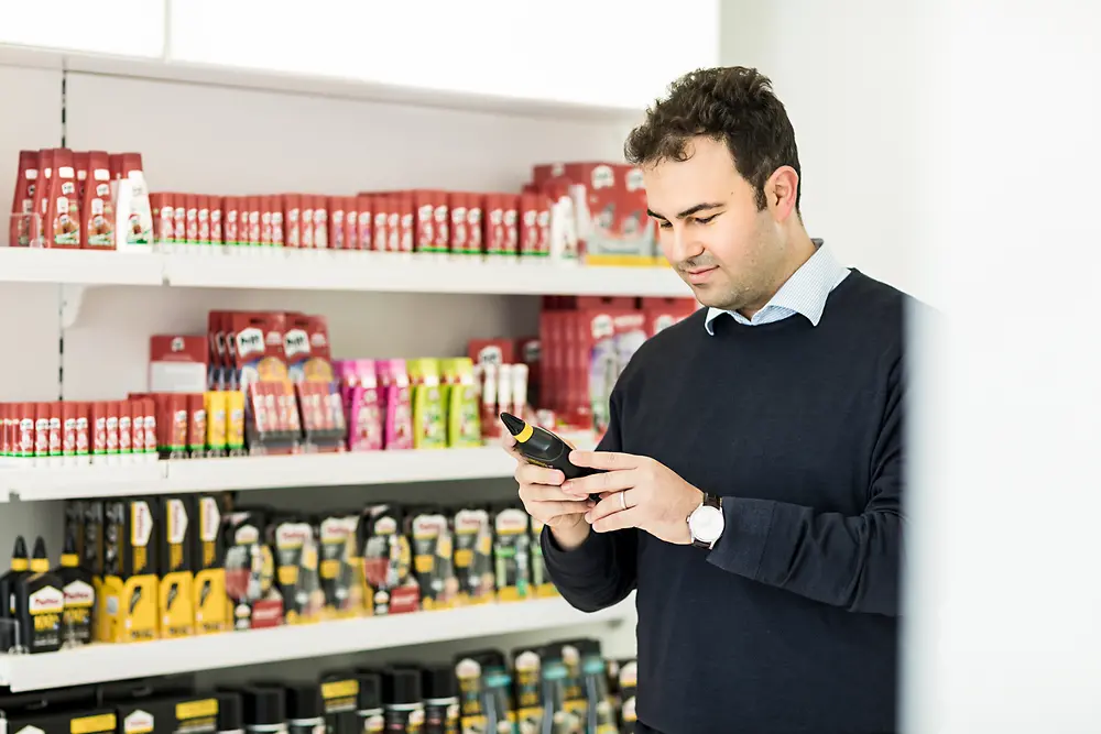 Consumer looking at Henkel Adhesive Products